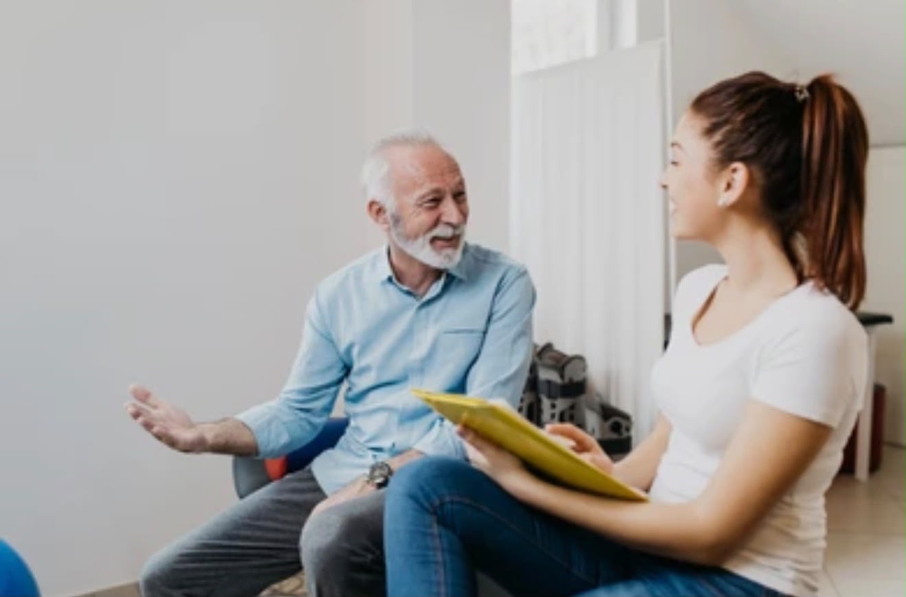 A care advisor talking with an older man
